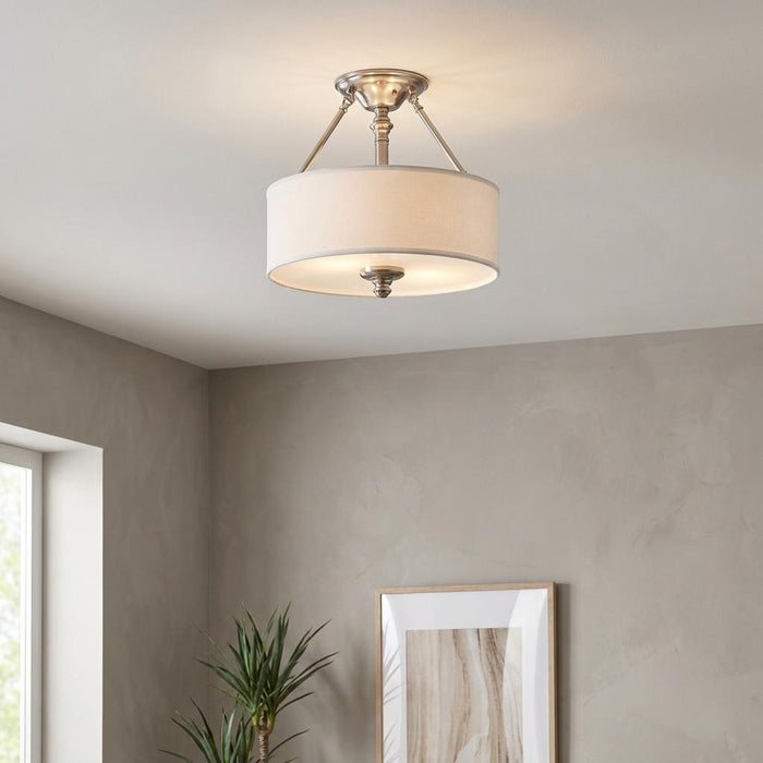 Hinkley Sussex nickel semi-flush ceiling light featuring a white fabric drum shade in a modern interior setting.