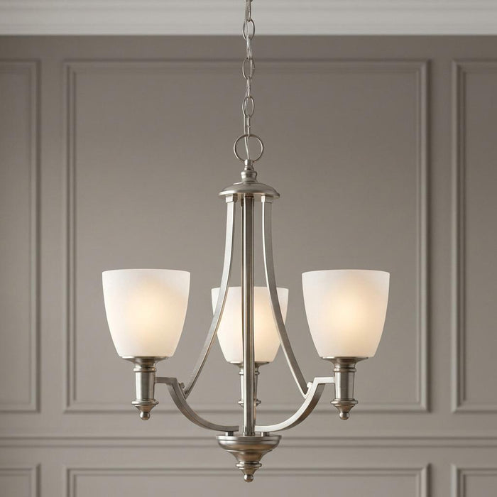 Three-light antique nickel chandelier with frosted glass shades hanging against a neutral paneled wall.