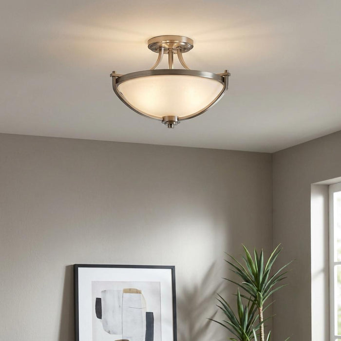 Hinkley Truman nickel semi-flush ceiling light with a frosted glass bowl in a modern grey interior.