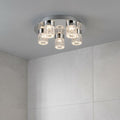 Modern 5-light chrome bathroom ceiling fixture with bubble glass cylinders mounted on a grey ceiling.