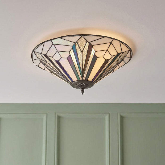 Art Deco Tiffany-style flush ceiling light with iridescent geometric glass panels mounted on a white ceiling.