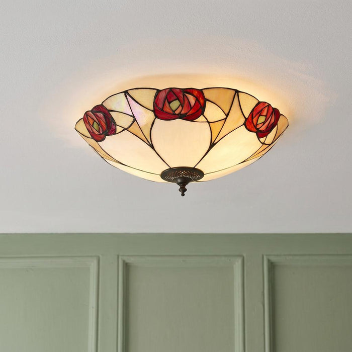 Mackintosh style red rose Tiffany flush ceiling light mounted on a white ceiling.