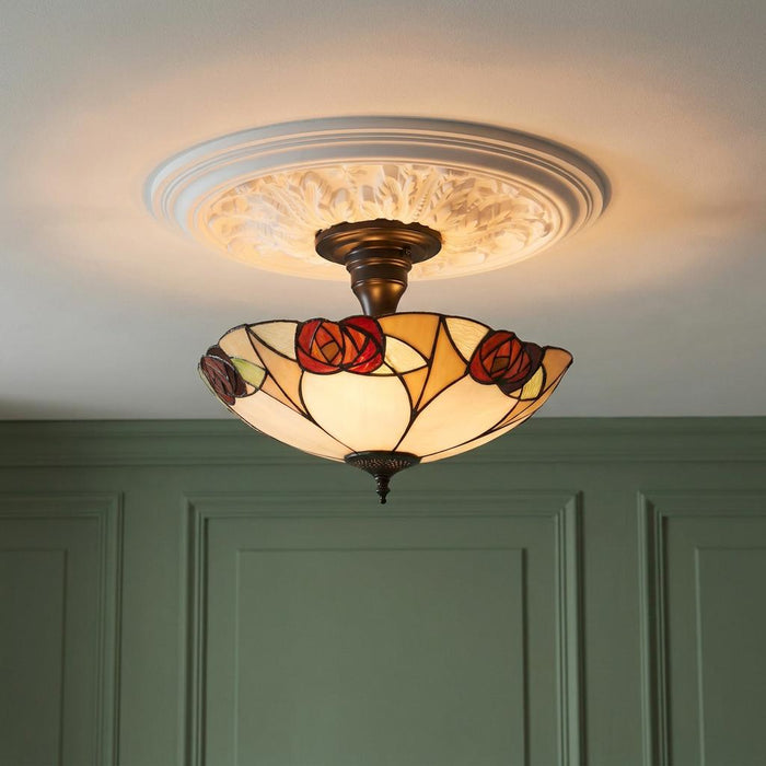 Tiffany semi-flush ceiling light with a red rose glass shade on an ornate white ceiling rose.