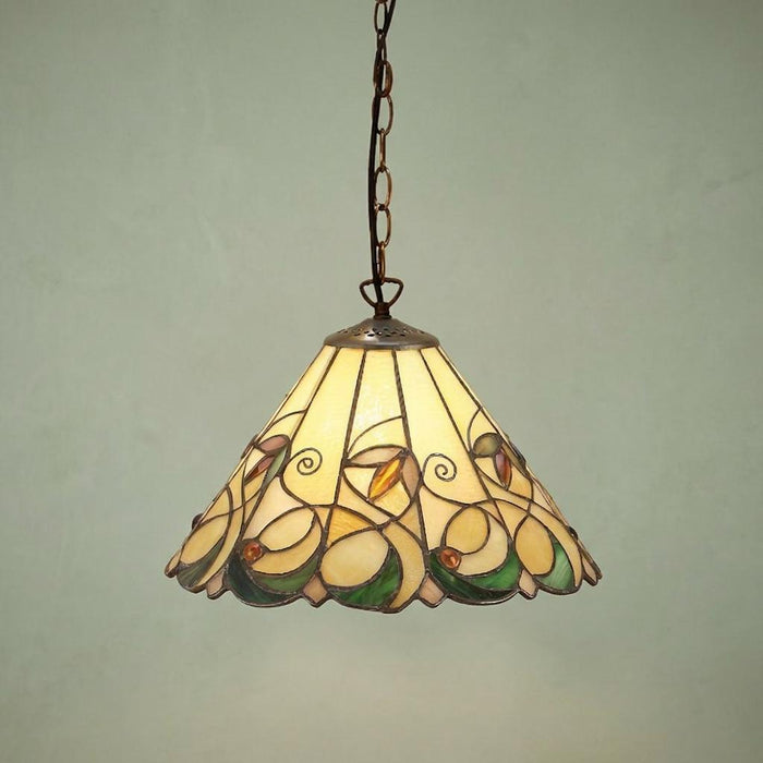 Small Tiffany pendant light with an intricate floral stained glass shade in amber and green hanging from a chain.