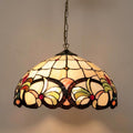 Ipswich Tiffany ceiling light with a floral stained glass dome shade hanging from a bronze-colored chain.