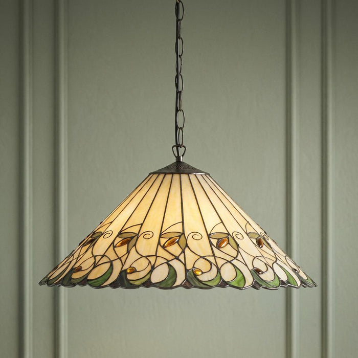 Tiffany-style ceiling light with a cream glass shade featuring green and amber floral patterns hanging by a chain.