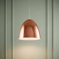 Polished copper dome pendant light hanging against a pale green panelled wall.