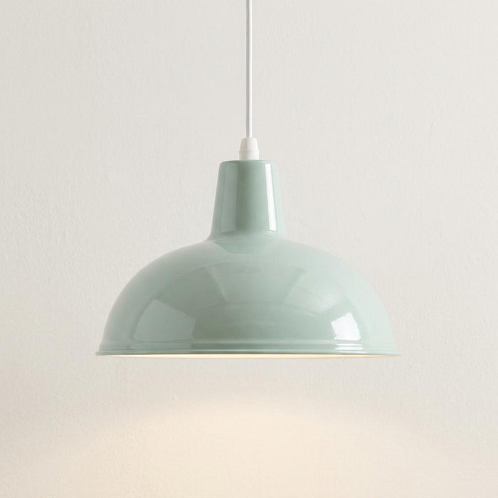 Glossy duck egg blue dome pendant ceiling light hanging from a white cord against a plain white wall.