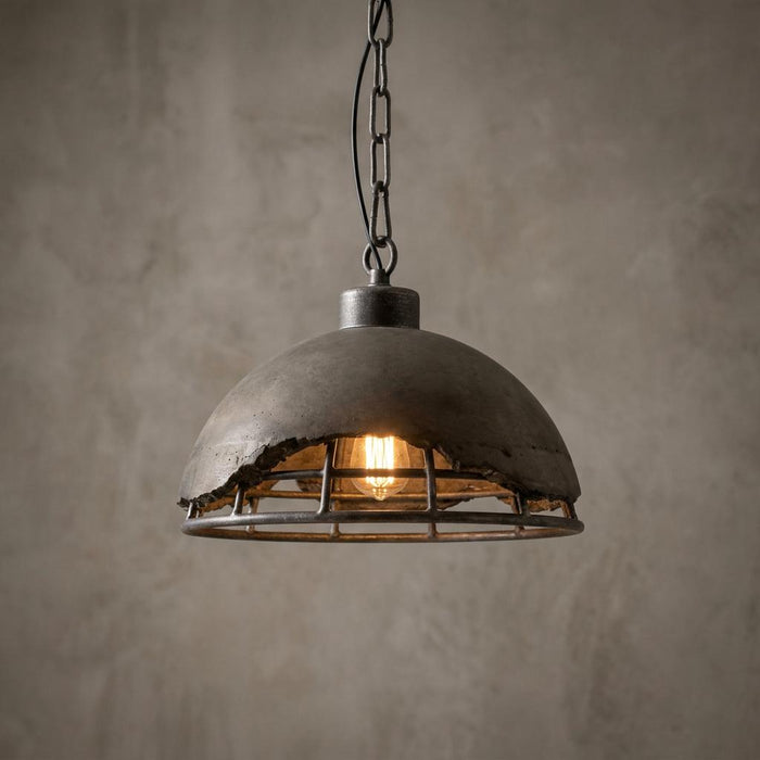 Kellen Concrete 1 Light Ceiling Light featuring a broken-edge concrete dome and metal cage with a filament bulb.