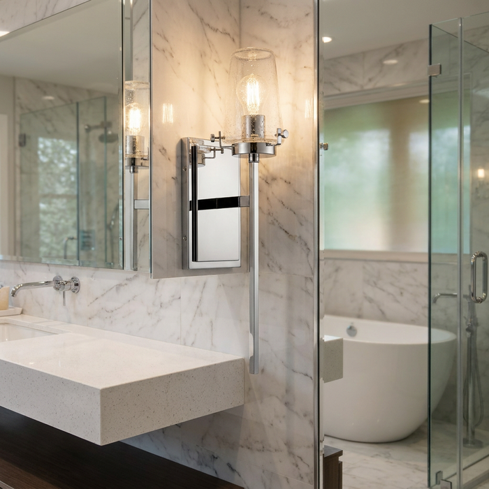 Kichler Alton chrome wall light with a seeded glass shade mounted on a marble wall in a modern bathroom.