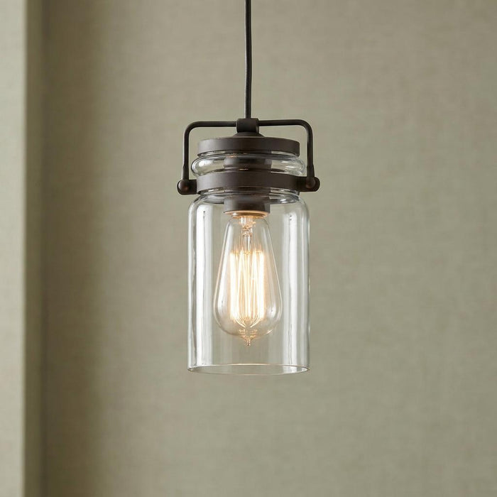 Kichler Brinley mini pendant light with Olde Bronze finish and clear jar glass shade housing a warm Edison bulb.