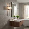 Pewter wall sconce with long vertical stems and a white shade on a grey tiled bathroom wall.