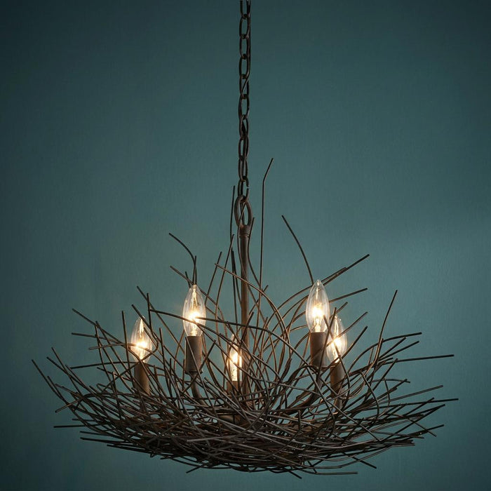 Five-light bronze chandelier with a unique bird's nest wire frame design against a blue background.