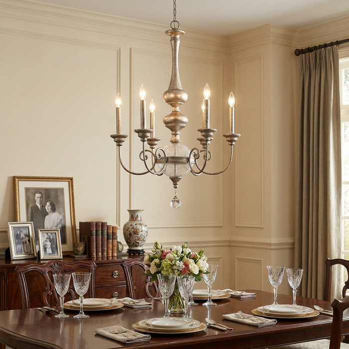 Kichler Rosalie gold chandelier with candle-style bulbs over an elegant dining room table set for a meal.