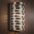 Kichler Roswell nickel wall sconce with glowing horizontal metal slats on a wood-paneled wall.