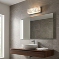 Rectangular chrome bathroom wall light with a geometric pattern, mounted above a large mirror and vessel sink.