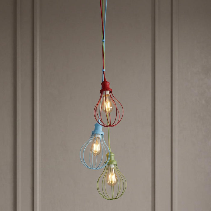 Three playful pendant lights with red, blue, and green balloon-shaped wire cages hanging at varying heights.