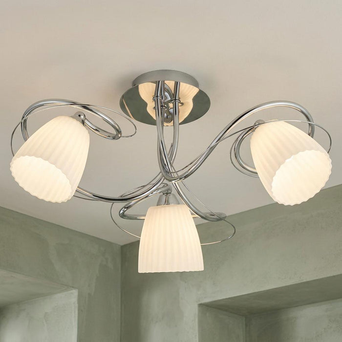Leke Chrome 3 light semi flush ceiling light with curved arms and three white ribbed glass shades.