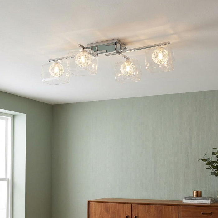 Lisbon 4 light chrome flush ceiling light with square glass shades and wire mesh inner bulbs.