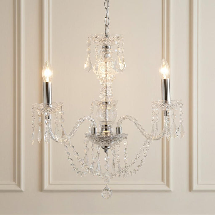 Marie Therese 3-light acrylic chandelier with clear droplets and glowing bulbs against a paneled wall.