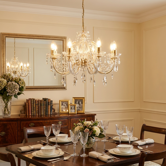 Marie Therese 8-light brass and clear crystal chandelier hanging above an elegantly set dining table.
