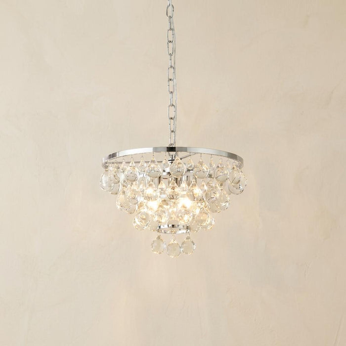 Michelle 4 light chrome ceiling pendant with tiered clear glass droplets, lit against a plain wall.