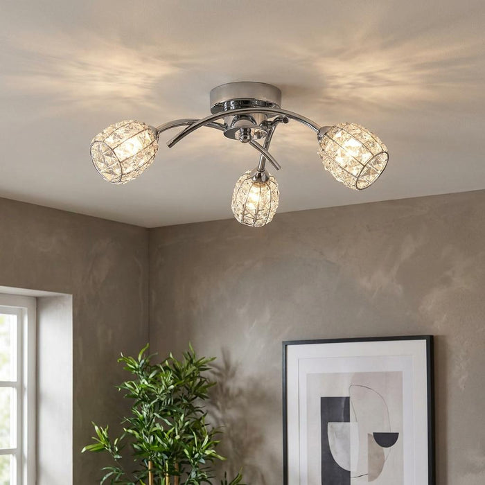 Naira 3 Light Chrome Flush Ceiling Light with crystal cage shades casting light patterns in a modern room.