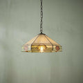 Nevada Medium Tiffany ceiling light with a geometric stained glass shade hanging against a light green wall.