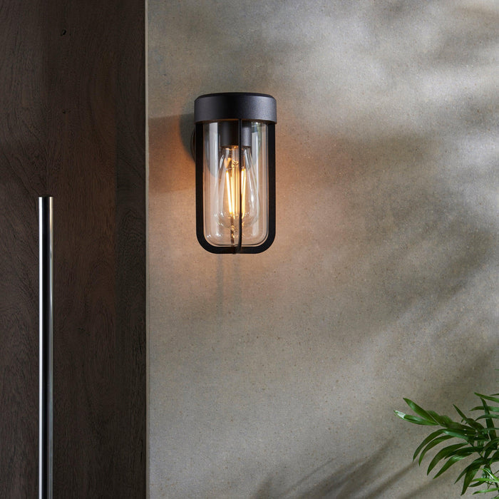 newquay black outdoor wall light with clear glass shade Close Up Lit Image