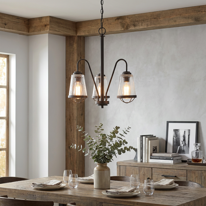 Oaks Bodo 3-light black chandelier with seeded glass shades hanging over a rustic wooden dining table.