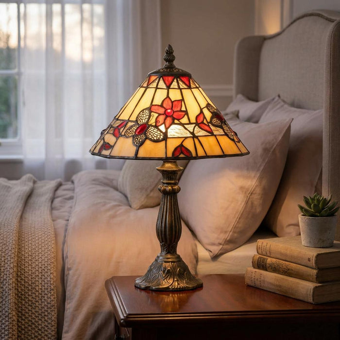 Oaks Butterfly Tiffany bedside table lamp with a floral stained-glass shade on a wooden nightstand.