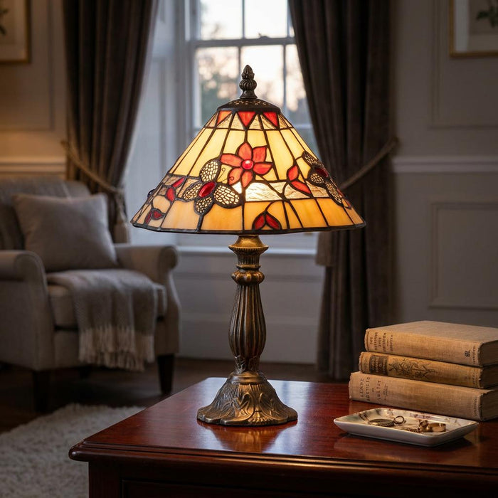 Oaks Butterfly Tiffany bedside table lamp with a floral stained-glass shade on a wooden table in a cozy living room.