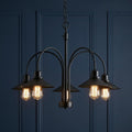 Oaks Dalvik 5-light black chandelier with conical shades and vintage filament bulbs against a dark blue wall.