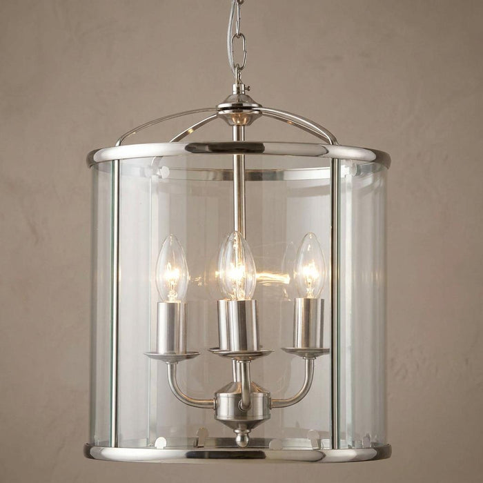 Oaks Fern antique chrome ceiling lantern with a cylindrical clear glass shade and candle-style bulbs.