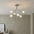Modern 6-light semi-flush ceiling fixture with chrome branches and clear glass globes in a contemporary room.