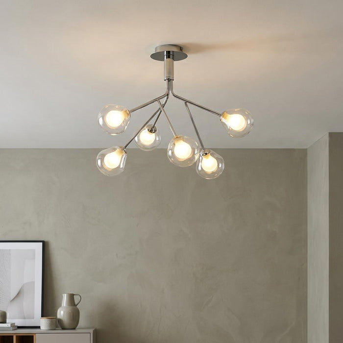 Modern 6-light semi-flush ceiling fixture with chrome branches and clear glass globes in a contemporary room.