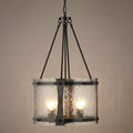 Oaks Inger 4-light black ceiling pendant with a cylindrical hammered glass shade and industrial metal frame.
