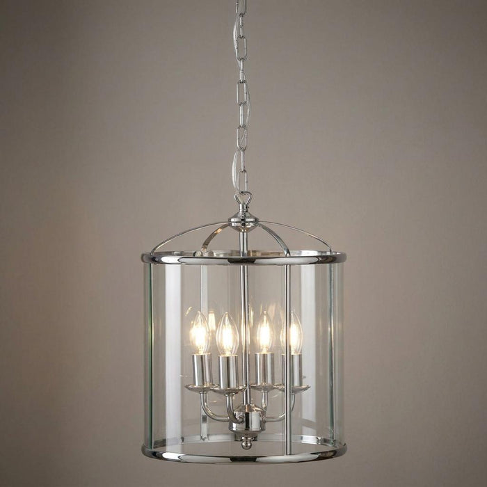Chrome 4-light cylindrical glass lantern with candle bulbs hanging from a chain.