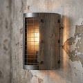 Oaks Lighting Harkin wall light with metal mesh and wood paneling on a textured concrete wall.