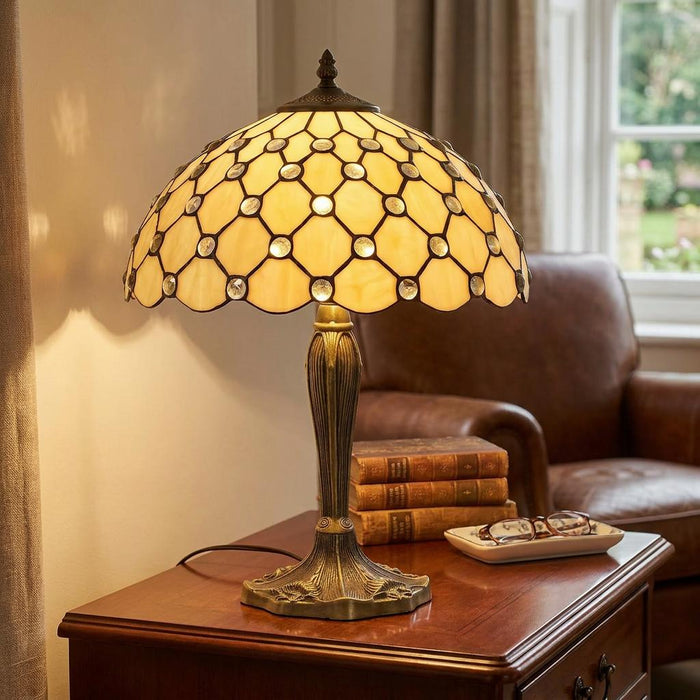 Oaks Lighting Jewel Tiffany table lamp with a cream glass shade and jewel details on a wooden side table.