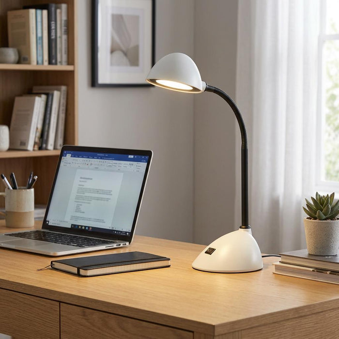Oaks Lighting Kade white LED desk lamp illuminates a wooden desk with a laptop and notebook in a home office.