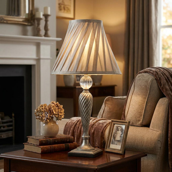 Oaks Lighting Lastur Soft Grey Table Light with a pleated shade on a living room side table.
