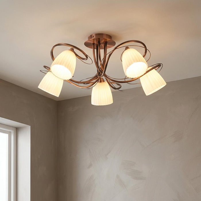 Five-light copper semi-flush ceiling fixture with elegant curved arms and frosted ribbed glass shades.