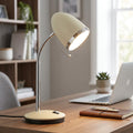Oaks Lighting Madison Cream Desk Lamp with chrome gooseneck and illuminated shade on a wooden desk in a home office.