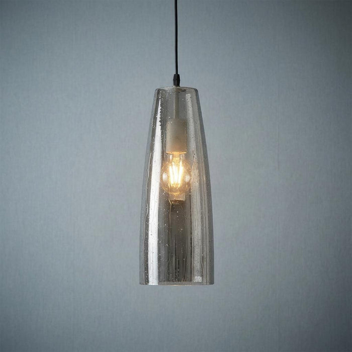 Oaks Lighting Oriata pendant with tapered smoked seeded glass and a warm filament bulb.