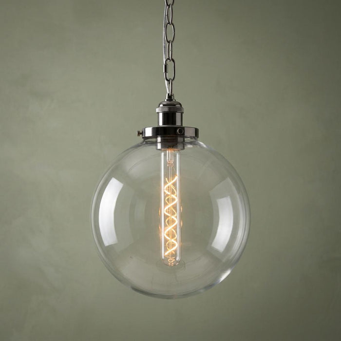 Black chrome and clear glass globe pendant light with a spiral filament bulb hanging from a silver chain.