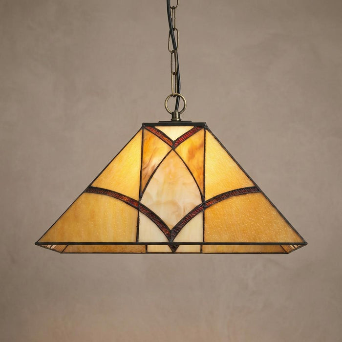 Trapezoidal Tiffany-style pendant light with amber glass and dark geometric patterns hanging from a chain.