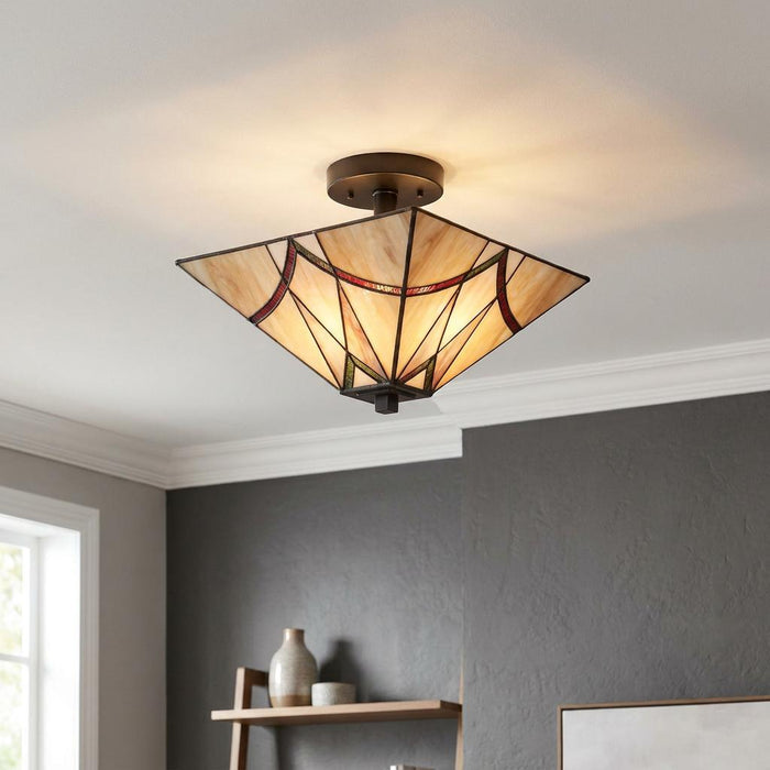 Geometric Tiffany-style semi-flush ceiling light with cream stained glass and colorful accents on a white ceiling.