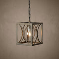 Matt silver square lantern pendant light with an internal glass globe and lit bulb hanging from a chain.