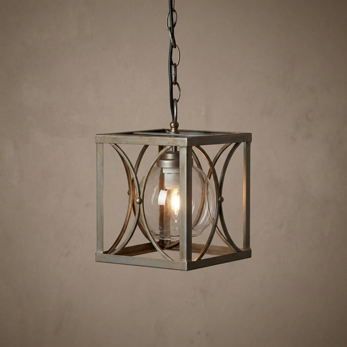 Matt silver square lantern pendant light with an internal glass globe and lit bulb hanging from a chain.